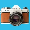 Pentax K1000 Brown Leather Vintage SLR 35mm Film Camera with Pentax f/2 50mm Prime Lens.