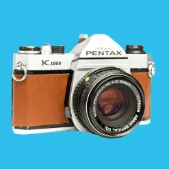 Pentax K1000 Brown Leather Vintage SLR 35mm Film Camera with Pentax f/2 50mm Prime Lens.