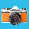Pentax K1000 Orange Leather Vintage SLR 35mm Film Camera with Pentax f/2 50mm Prime Lens.