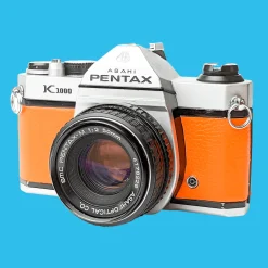 Pentax K1000 Orange Leather Vintage SLR 35mm Film Camera with Pentax f/2 50mm Prime Lens.