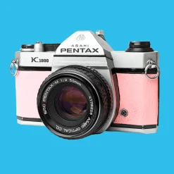 Pentax K1000 Pink Leather Vintage SLR 35mm Film Camera with Pentax f/2 50mm Prime Lens.