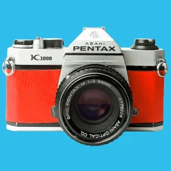 Pentax K1000 Red Leather Vintage SLR 35mm Film Camera with Pentax f/2 50mm Prime Lens.