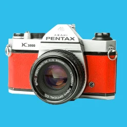 Pentax K1000 Red Leather Vintage SLR 35mm Film Camera with Pentax f/2 50mm Prime Lens.
