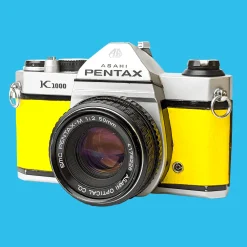 Pentax K1000 Yellow Leather Vintage SLR 35mm Film Camera with Pentax f/2 50mm Prime Lens.